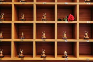 a bunch of bells on a shelf with a rose at Romania in Karlovy Vary