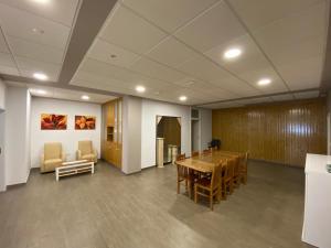 a conference room with a wooden table and chairs at dpCristal El Rinconcito in Sarria