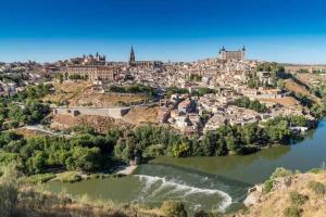 a view of a city from the river at Apartamentos Dimax by Toledo AP in Toledo