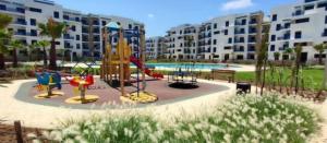 a playground in a apartment complex with a slide at COSTA MAR MARTIL TETOUAN in Martil