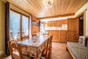 a dining room with a table and a kitchen at Apt Chénives 1 - Morzine in Morzine