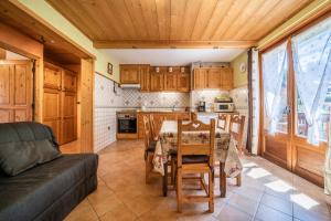 a kitchen and dining room with a table and a couch at Apt Chénives 2 - Morzine in Morzine