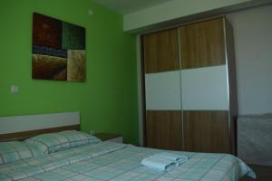 una camera verde con letto e armadio di Apartmani Tomljenović a Senj