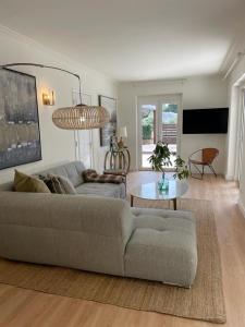 a living room with a couch and a table at Villa Shaz Cascais in Cascais