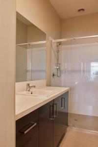 a bathroom with a sink and a shower at Vine Close Apartment in Healesville