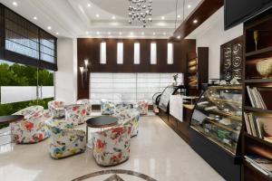 a lobby with chairs and a table and a store at Inn Riviera Jammu in Jammu +21 photos