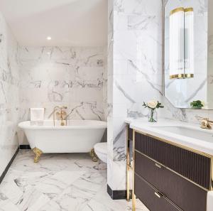 a bathroom with a tub and a sink at The Westbury Hotel in Dublin