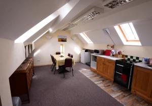 a kitchen with a table and a dining room at Station Cottage in Kirkby Stephen