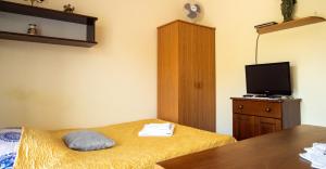 a hotel room with two beds and a television at Willa Bliska in Gdańsk