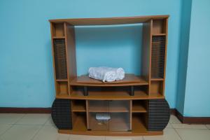 a tv cabinet with a towel on top of it at 3 bedroom Apartment in Dar es Salaam