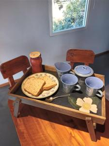 a wooden table with a plate of bread on it at Cabaña Los Ulmos Bariloche in San Carlos de Bariloche