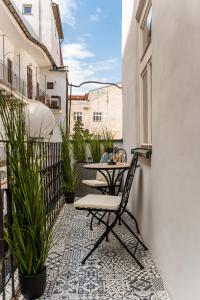 a patio with a table and chairs on a balcony at Hlavna Apartment Kosice in Košice +59 photos