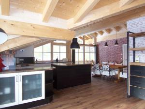 eine offene Küche und ein Esszimmer mit Holzdecken in der Unterkunft Ferienwohnung Rustica mit Bergbahn unlimited in Obermaiselstein