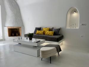 a living room with a couch and a coffee table at Aidos Villa Santorini in Megalokhori