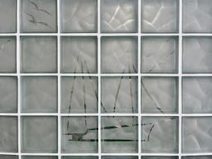 a collage of glass windows with reflections in them at Aidos Villa Santorini in Megalokhori