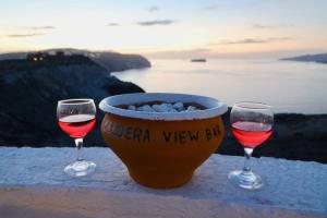 two glasses of red wine next to a bowl of wineaband at Aidos Villa Santorini in Megalokhori