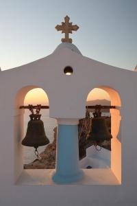 a church with bells and a cross on top at Aidos Villa Santorini in Megalokhori