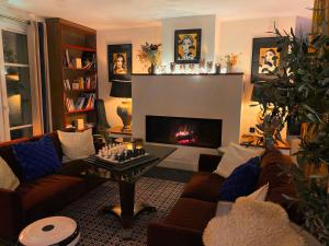 a living room with a couch and a fireplace at Hôtel Des Gouverneurs in Bastia