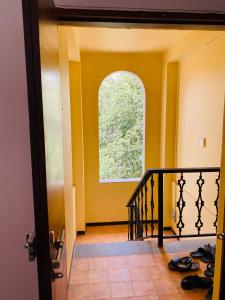 a hallway with a staircase with a window at Nirvan in Varca