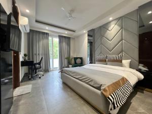 a bedroom with a large bed and a desk at Bed&Oats Studios in Gurgaon