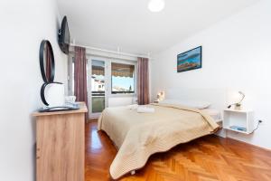 a bedroom with a bed and a television in it at Casa Caterina by Irundo in Rovinj
