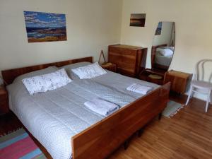 a bedroom with a large bed with two pillows at Rooms Apartma Cerknica in Cerknica
