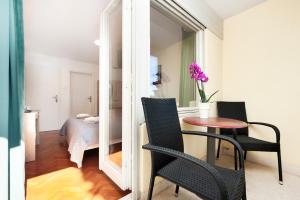 a room with a table and chairs and a bedroom at Casa Caterina by Irundo in Rovinj