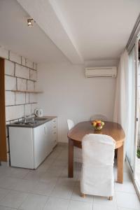 a small kitchen with a table and a sink at Apartments Kiki in Dubrovnik