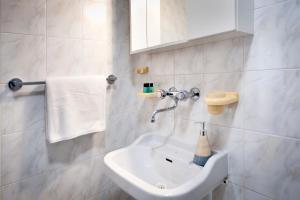 a white bathroom with a sink and a towel at Casa Caterina by Irundo in Rovinj +47 photos