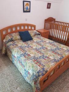 a bed with a quilt on it in a bedroom at Cueva Maite in Cortes de Baza