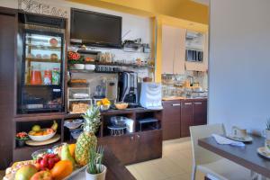 a kitchen with a counter with fruit on a table at B&B Studio83 Pompei in Pompei