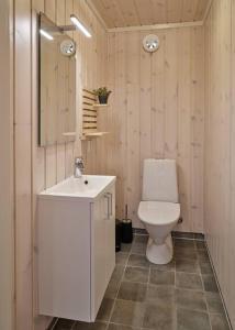a bathroom with a white toilet and a sink at Panorama View in Stranda