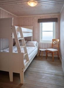 a bedroom with two bunk beds and a chair at Panorama View in Stranda