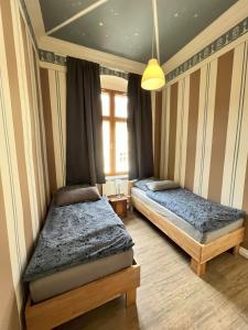 a bedroom with two beds and a window at Alte Post Sondershausen in Sondershausen
