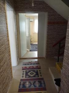 a hallway with a tile floor and a stairway with a room at ESKA 121 airport in Dalaman