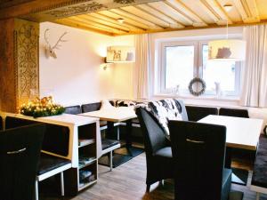 a dining room with tables and chairs and a window at Fantastic chalet in Saalbach Hinterglemm Salzburgerland for 22 people in Saalbach Hinterglemm