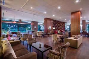 a lobby with couches and tables and chairs at Acapulco Resort Hotel in Kyrenia