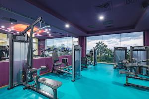 a gym with treadmills and exercise equipment at Acapulco Resort Hotel in Kyrenia +150 photos