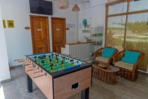 a room with a table with a large chess board at Nihaali Maldives in Kudarikilu