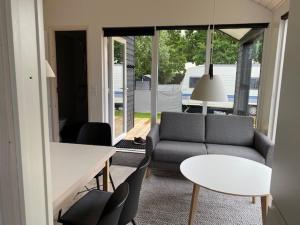 a living room with a couch and a table at Rosenvold Strand Camping in Stouby