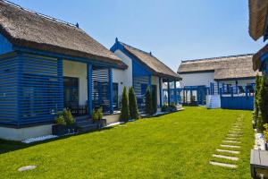 a row of blue and white houses with a yard at Déjà Blue - ADULT ONLY in Sfântu Gheorghe