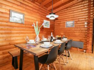 a wooden dining room with a table and chairs at Rocksite in Blairgowrie