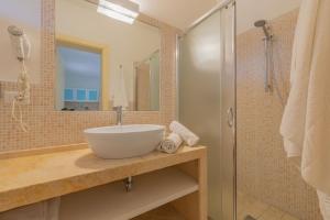 a bathroom with a sink and a shower at Cava Li Santi Residence a Santa Caterina in Nardò