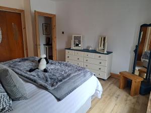a bedroom with a bed with a teddy bear on it at The Apartment in Aberlour in Aberlour