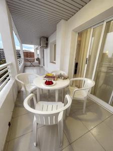 a white table and chairs on a balcony at Royal in Salou