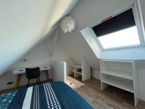 a bedroom with a bed and a window and a desk at STUDIO SCANDINAVE - HYPER CENTRE LORIENT in Lorient