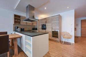 a kitchen with a counter and a table in a room at SonnenChalet Appartement SC 03 in Pfronten