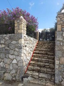 a stone stairway with a stone wall and a fence at Το σπιτάκι στη Μουρνέ in Dharivianá