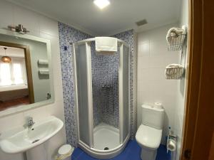 a bathroom with a shower and a toilet and a sink at dpCristal LikeHome in Sarria