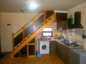 a kitchen with a staircase in the middle of a house at Aygestan Comfort Holiday Home in Yerevan